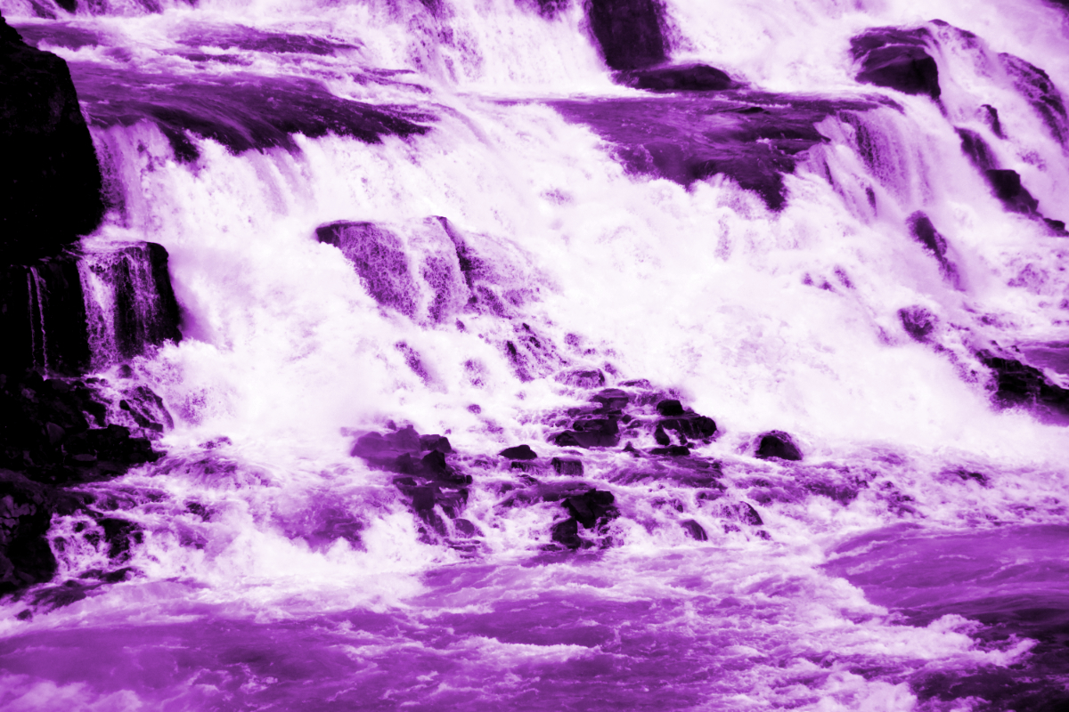 a high-contrast purple hued closeup of an Icelandic waterfall