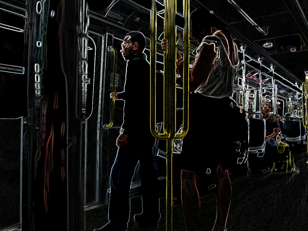 people on a subway, most sitting with a couple of vacant seats available, with two standing by the door waiting to get off. The image is given a sort of metallic neon feel, making the subway mostly dark but bright things like the handrail stand out more.