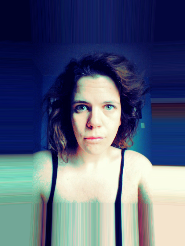 a thick border of blurry lines extending the colours from the image, with a teal-purple hued image of a pale white person with messy hair and a distressed look on their face wearing a thin strapped black tanktop staring right into the camera