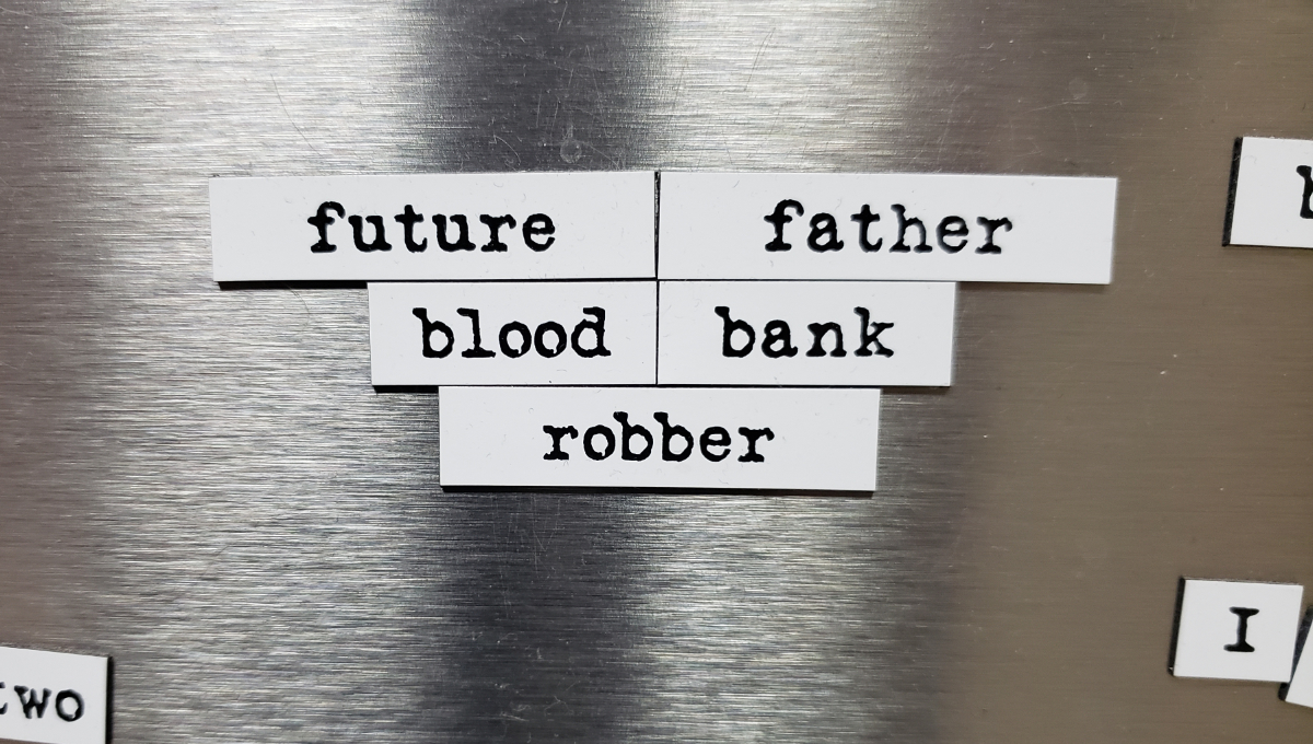 magnetic poetry on a stainless steel fridge saying, in three lines all center-justified, 'future father / blood bank/ robber'