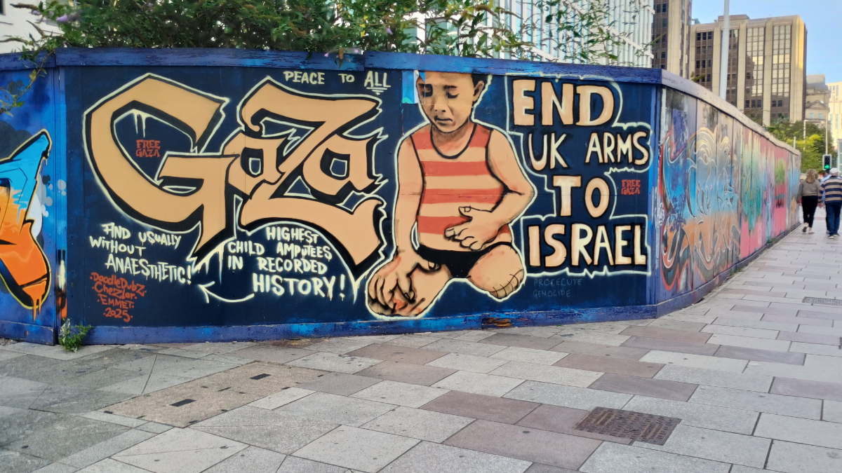 Cardiff, UK A wooden wall around a construction site with a mural of a small sad child with amputated legs and 'GAZA' in large letters, with additional text saying 'Highest child amputees in recorded history! And usually without anaesthetic!' and 'End UK Arms to Israel'