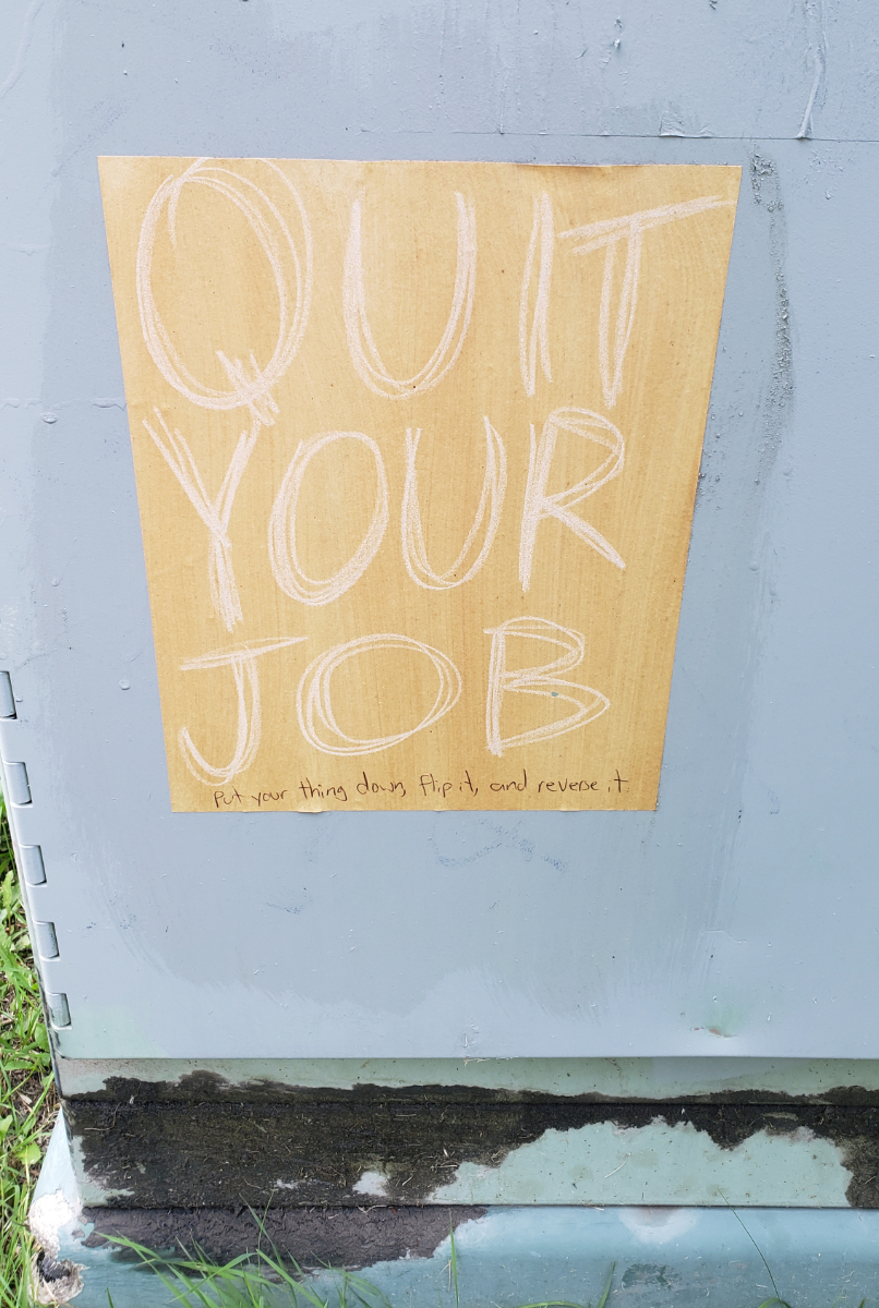 A QUIT YOUR JOB poster with 'Put your thing down, flip it and reverse it' written in pen.