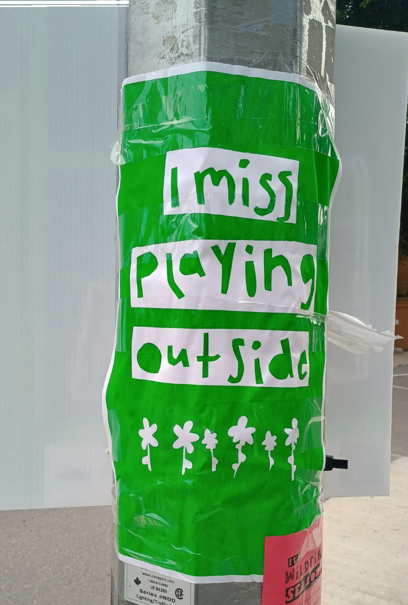 a green poster with white boxes with letters cut out saying 'i miss playing outside' and small white flowers at the bottom