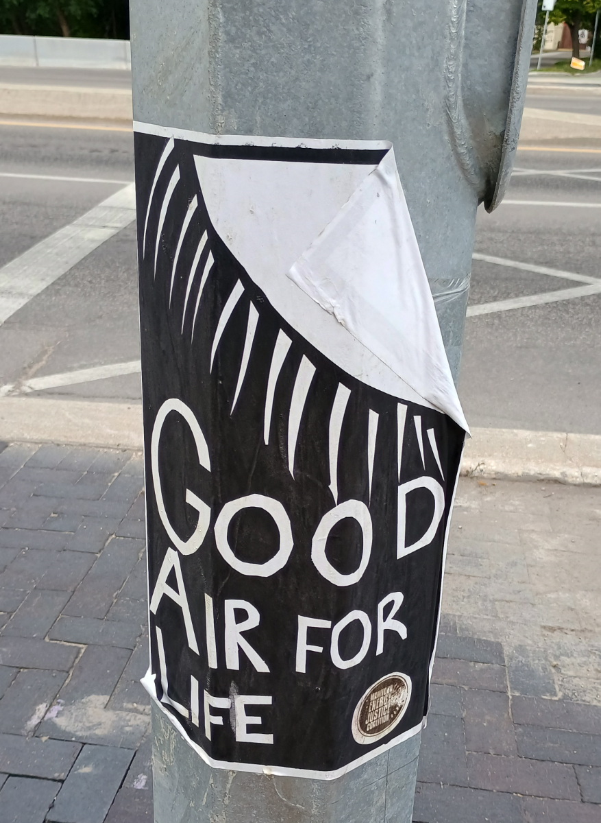 a black poster with a giant white sun in the top right corner and text saying 'good air for life' filling the rest of the page