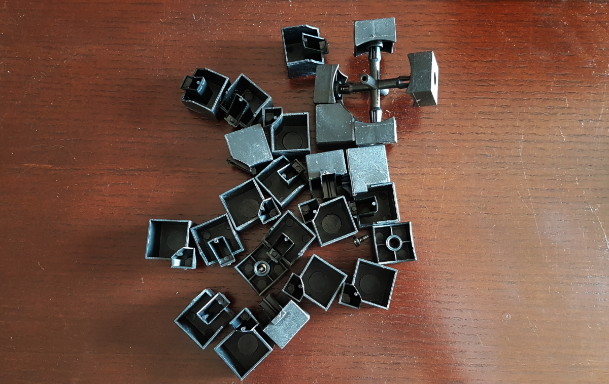 The surface of a dark brown coffee table with a disassembled Rubik's cube on it.